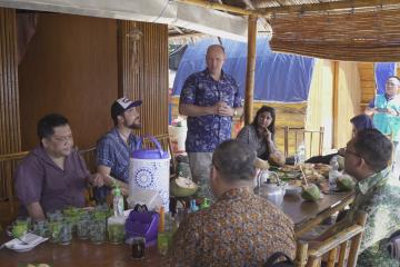 Delegates enjoy refreshments on Pulau Tiga.